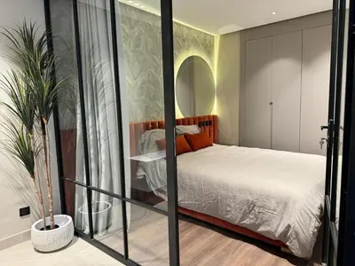 a bedroom with a bed in a room with a mirror at الدار بيضاء in Casablanca