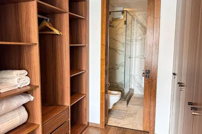 a bathroom with a toilet and a glass shower at Luxury business 70m apartment -CFC AERIA Mall Casa in Casablanca
