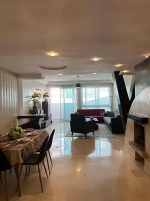 a living room with a table and a fireplace at Golden Triangle Apartment Rental in Casablanca