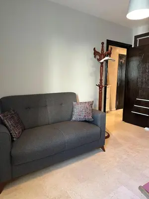 a living room with a couch and a cross at Golden Triangle Apartment Rental in Casablanca