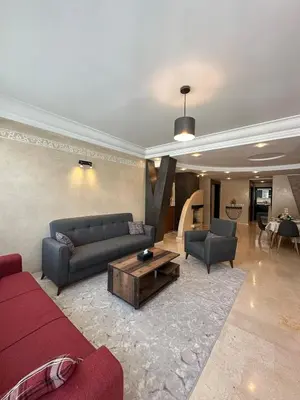 a living room with a couch and a coffee table at Golden Triangle Apartment Rental in Casablanca