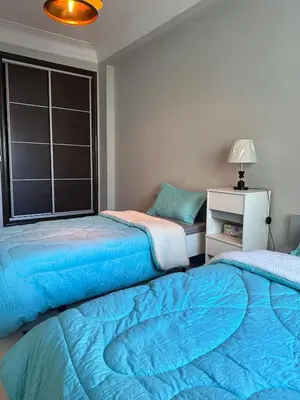 a bedroom with two beds and a window at Golden Triangle Apartment Rental in Casablanca