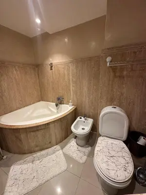 a bathroom with a tub and a toilet and a sink at Golden Triangle Apartment Rental in Casablanca