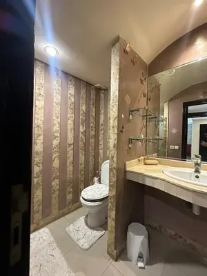 a bathroom with a toilet and a sink at Golden Triangle Apartment Rental in Casablanca