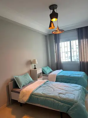 a bedroom with two beds and a window at Golden Triangle Apartment Rental in Casablanca