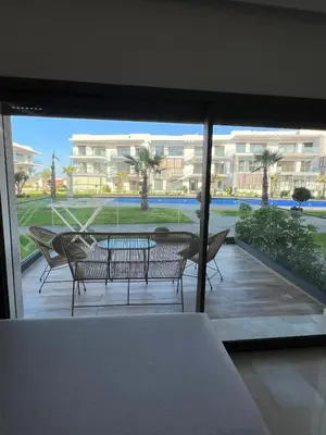 a view of a patio with a table and chairs at Luxury 2 bedroom flat in Tamaris Dar Bouazza in Casablanca