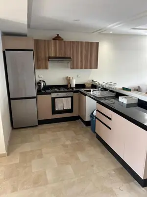 a kitchen with a stove and a refrigerator at Luxury 2 bedroom flat in Tamaris Dar Bouazza in Casablanca