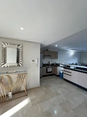 a large kitchen with white cabinets and a mirror at Luxury 2 bedroom flat in Tamaris Dar Bouazza in Casablanca