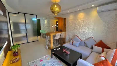 a living room with a couch and a table at N42 Luxe et Élégance avec Jacuzzi Privatif sur la Corniche Rabat Essabah in Rabat