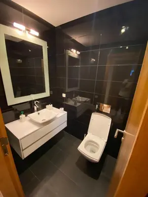 a bathroom with a toilet and a sink and a mirror at Marina Apartment Ocean View BY AppartAyla in Casablanca