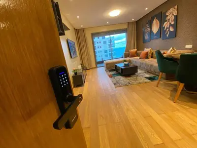 a living room with a couch and a table at Marina Apartment Ocean View BY AppartAyla in Casablanca