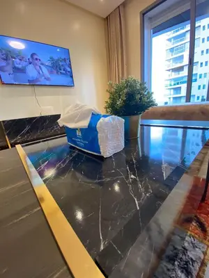 a table in a room with a fish tank on it at Marina Apartment Ocean View BY AppartAyla in Casablanca