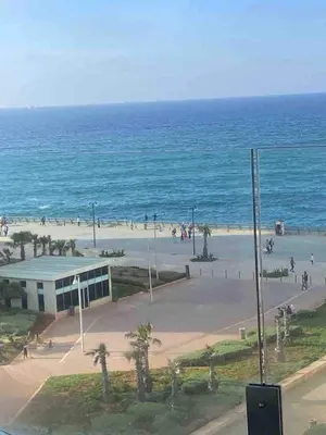 a group of people on the beach near the ocean at Marina Apartment Ocean View BY AppartAyla in Casablanca