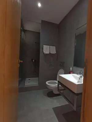 a bathroom with a toilet and a sink and a shower at superbe appart a dar bouaza tamaris avec piscine in Casablanca