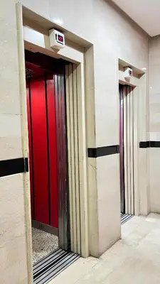 three elevators in a building with a red door at SUITOUISS - AGDAL 5 - Appartements à 2 minutes de la gare de train TGV Rabat in Rabat