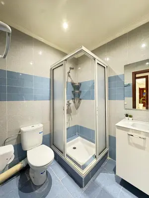 a bathroom with a shower and a toilet and a sink at SUITOUISS - AGDAL 5 - Appartements à 2 minutes de la gare de train TGV Rabat in Rabat