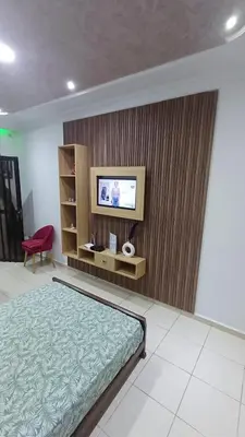 a bedroom with a bed and a flat screen tv at Studio confortable in Rabat