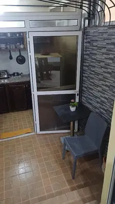 a kitchen with a table and a chair in a room at Studio confortable in Rabat