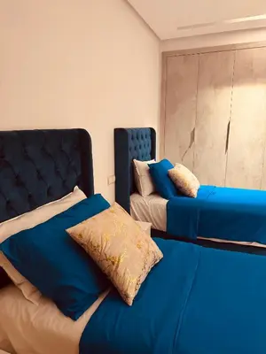 two beds sitting next to each other in a bedroom at Modern Comfort with Moroccan Soul in Casablanca
