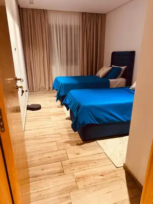 a room with three beds with blue sheets at Modern Comfort with Moroccan Soul in Casablanca