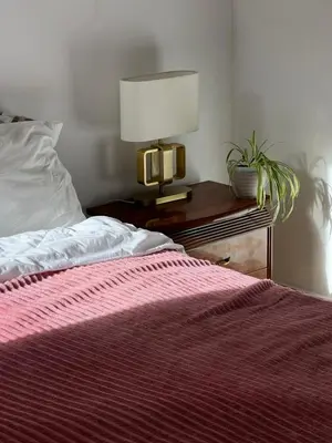 a bedroom with a bed and a lamp on a table at Private room 2 in Casablanca