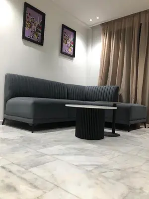 a living room with a couch and a table at AbboGroup APPARTEMENT in Casablanca