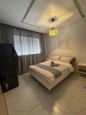 a bedroom with a bed and a chandelier at Stylish Cozy Condo Downtown City Center Casablanca in Casablanca