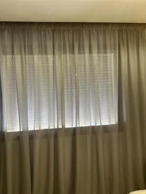 a window with white curtains in a bedroom at Stylish Cozy Condo Downtown City Center Casablanca in Casablanca