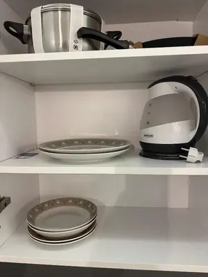 a kitchen shelf with plates and a toaster at Stylish Cozy Condo Downtown City Center Casablanca in Casablanca
