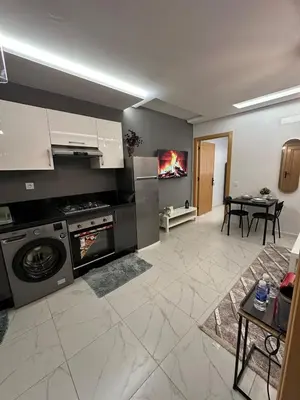 a kitchen with a washing machine and a dining room at Stylish Cozy Condo Downtown City Center Casablanca in Casablanca
