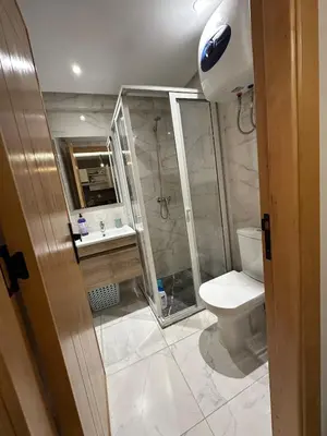 a bathroom with a toilet and a shower and a sink at Stylish Cozy Condo Downtown City Center Casablanca in Casablanca