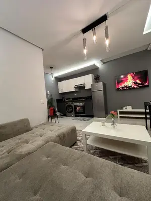 a living room with a couch and a table at Stylish Cozy Condo Downtown City Center Casablanca in Casablanca