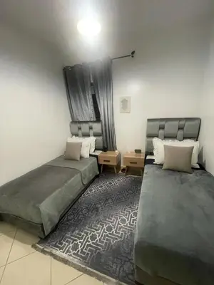 a bedroom with two beds and a rug at Blue Beach & Sunny Life in Skhirate in Skhirat