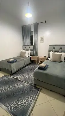 a living room with two beds and a couch at Blue Beach & Sunny Life in Skhirate in Skhirat