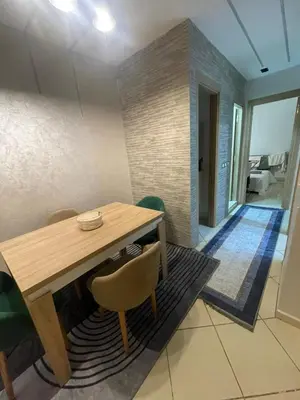 a dining room with a wooden table and chairs at Blue Beach & Sunny Life in Skhirate in Skhirat