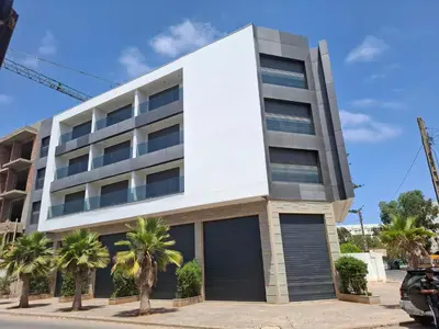 a building with palm trees in front of it at Studio 27 in Casablanca