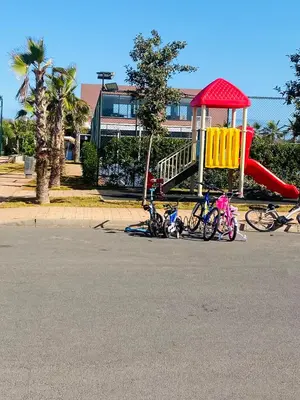 a group of bikes parked next to a playground at Sidi rahal blue beach Cozy apartment with a sea view in Sidi Rahal