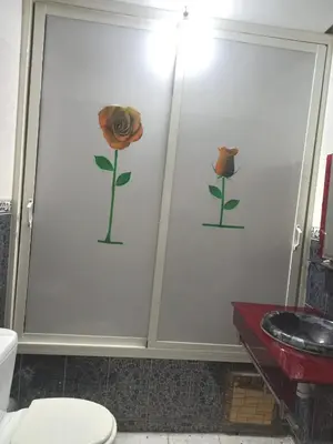 a bathroom with a flower on the wall and a toilet at Hyatt Residence Casa Voyageur in Casablanca