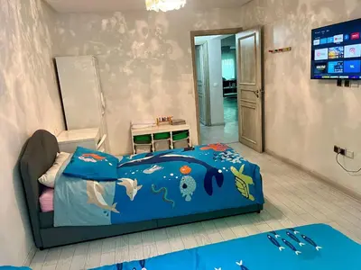 a childs bedroom with a blue bed with fish on it at Stylish apartment - March 2 in Casablanca