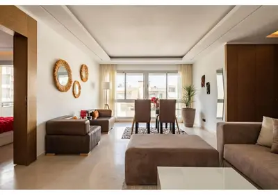 a living room with a couch and a table at Cosy cocon urbain 34 in Rabat