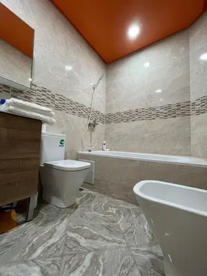 a bathroom with a toilet and a tub and a sink at Yalla Morocco in Temara