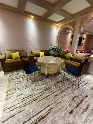 a living room with a couch and a table at Yalla Morocco in Temara