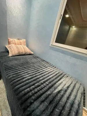 a bed in a room with a window at Yalla Morocco in Temara