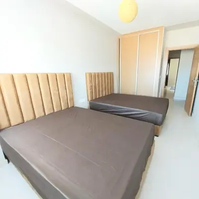 a small room with two beds and a closet at Family airport relax apartment in Deroua