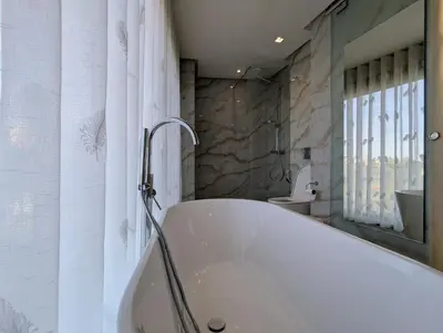 a white bath tub in a bathroom with a toilet at Seafront Luxury Villa with Amazing pool! in Dar Bouazza