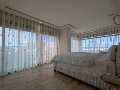 a bedroom with a large bed and large windows at Seafront Luxury Villa with Amazing pool! in Dar Bouazza