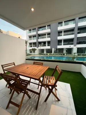 a wooden table and two chairs on a balcony at ZS house harhoura in El Harhoura
