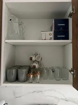 a cupboard filled with lots of glass items at ZS house harhoura in El Harhoura