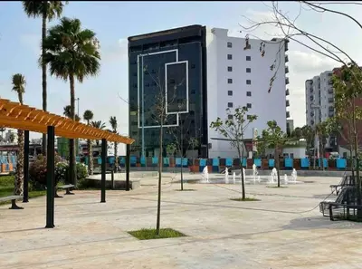 a large building with a basketball hoop in a parking lot at Charmant studio in Casablanca
