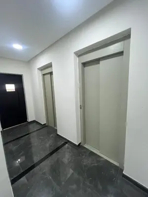 an empty room with two sliding doors in a building at Charmant studio in Casablanca